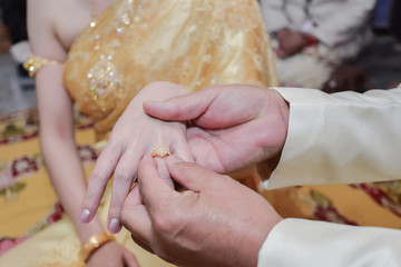 Wedding ring.Groom put the wedding ring on bride.Thai traditional wedding ceramony decoration