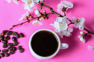 a cup of coffee, coffee beans with apricot flowers