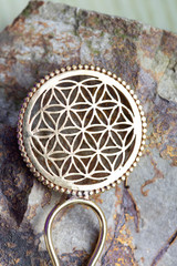 Brass metal yellow golden hair pin detail on natural rocky background