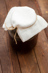 glass jar with harvesting on wooden background.