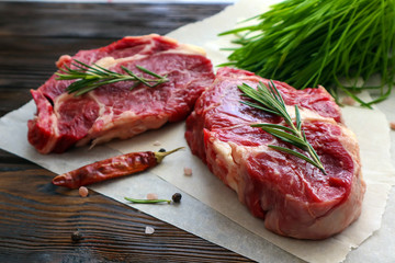 Fresh beef steaks on wooden table
