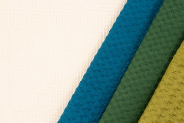 Fototapeta premium waffle towel of different colors on a white background.copyspace for text
