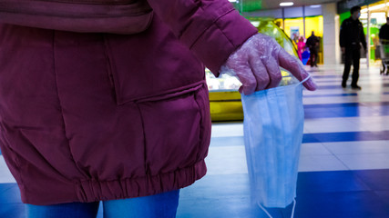 the girl has a protective mask in her hand