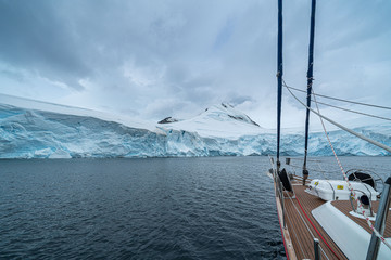 sailing boat in Antarctica, yacht navigation through icebergs and sea ice © suvorovalex