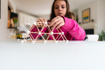 Children working on building a structure for a homeschool STEM project