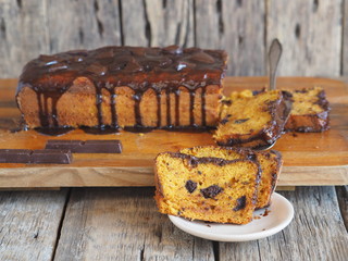 Homemade chocolate pumpkin muffin, ready to eat, on a wooden background.