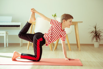 Teen boy having sport lesson at home due to coronavirus quarantine © spass