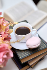cup of coffee with marshmallows on books