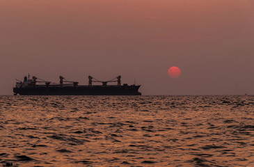 Silhouette Logistics and transportation of International Container Cargo ship in the ocean