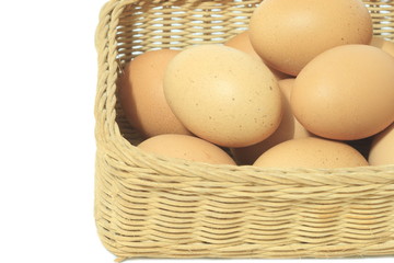 Eggs in basket isolated on white background