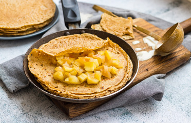 Crepes or thin pancakes on nonstick frying pan skillet. Making dessert. Vegan food.