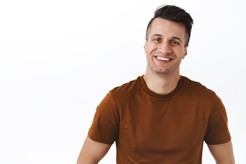 Waist-up portrait of handsome friendly-looking kind man smiling at something pleasant and adorable, make positive reaction on something really good, express happiness and delight