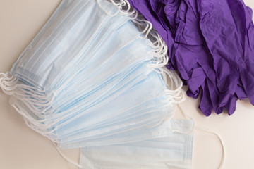 Disposable medical masks and disposable gloves on a white background