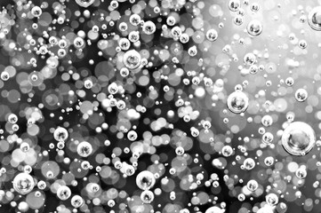 Blurred black and white background. Macro Oxygen bubbles in water.  Concept such as ecology