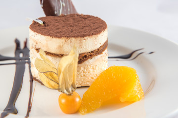 Tiramisu dessert plate with a physalis.