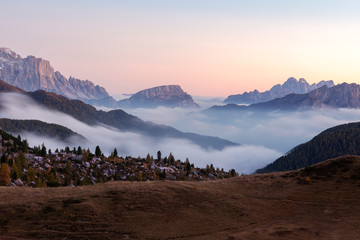 Italian Dolomites, Valparola valley, Position Edelweiss, sunset view of Valparola valley where fog with beautiful light rolls over