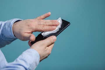 Man disinfects smartphone