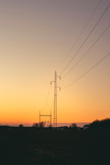 Fototapeta na wymiar Electrical pylons at dawn