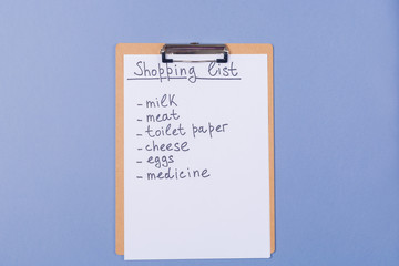 Handwriting Shopping list of products on clipboard. Free copy space. Ready for shopping. Internet shopping. Distant shopping concept. 
