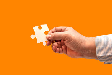 hand holding piece of jigsaw puzzle