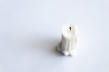 white extinguished candle on an isolated background