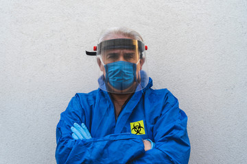 portrait of single man in quarantine dressed in protective suit and protective visor