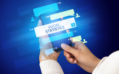 Female hand typing on smartphone with SOCIAL STATISTICS inscription, social networking concept