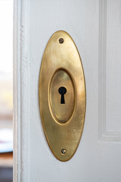 Vintage brass lock to a freshly painted white pocket door
