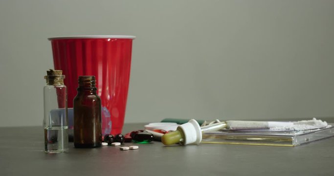 Beer cocaine quaaludes and other drugs on counter - side profile