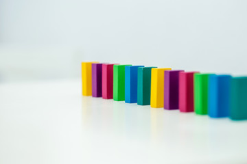 The concept of the Domino effect. Color wooden children's constructor.