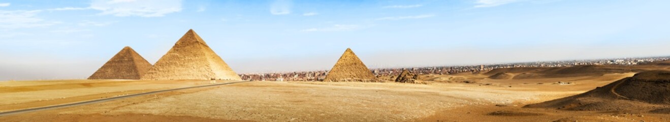 Fototapeta na wymiar Pyramids of Giza on Sahara desert and city of Cairo at the background