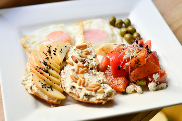 food, fried eggs with vegetables and toast on a plate