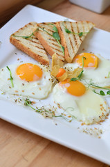 food, fried eggs with vegetables and toast on a plate