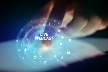 Finger touching tablet with social media icons and LIVE WEBCAST