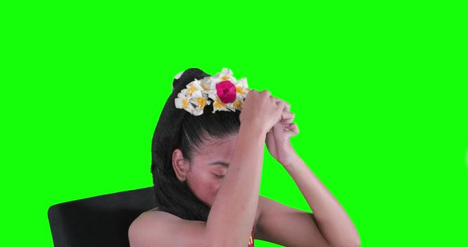 Beautiful balinese woman fixing accessories crown