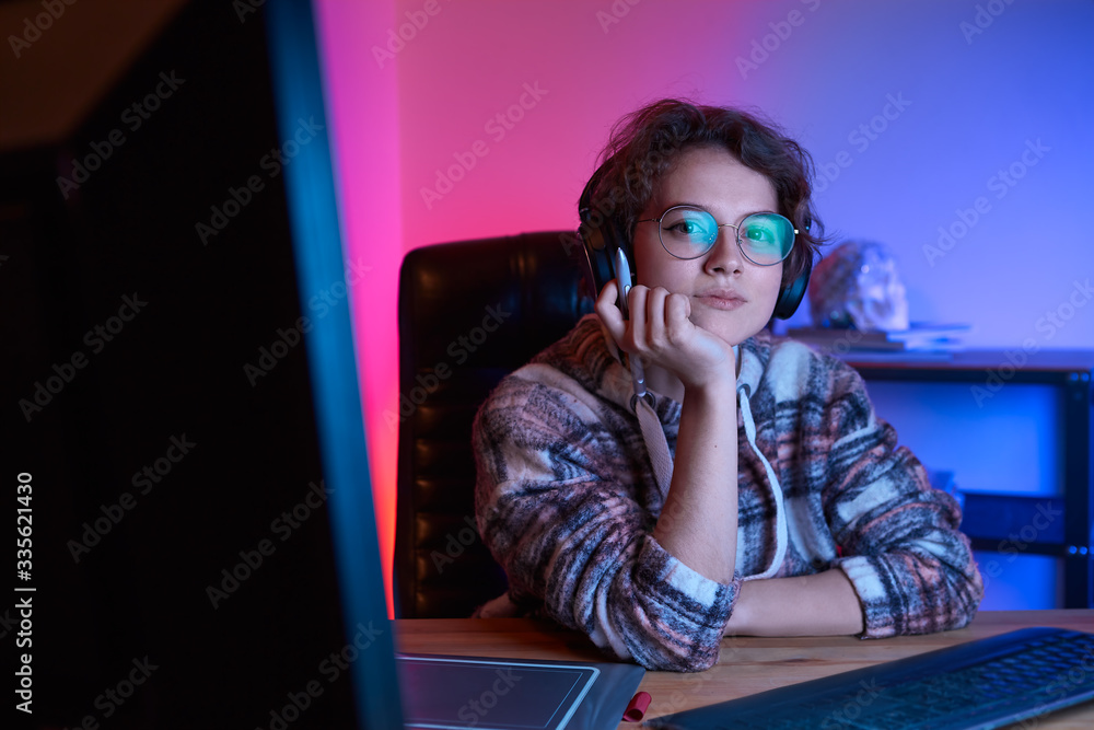 Fototapete freelancer desinger working from home using graphic tablet and stylus with neon light at the back
