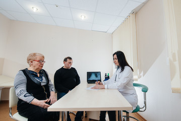 A couple of elderly people at a personal doctor's appointment at a medical center. Medicine and healthcare