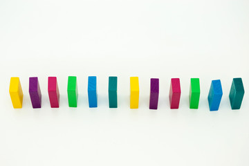 The concept of the Domino effect. Color wooden children's constructor.
