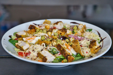 Gemischter Bio Salat Teller mit Hühnchenstreifen, Tomaten, Eier, Paprika, Feldsalast, Balsamico und Croutons, Produktbild