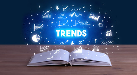 TRENDS inscription coming out from an open book, business concept