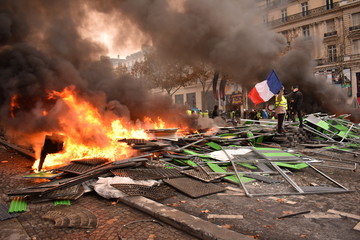 Pile of things burning on the street by yellow vest protestors in Paris France
