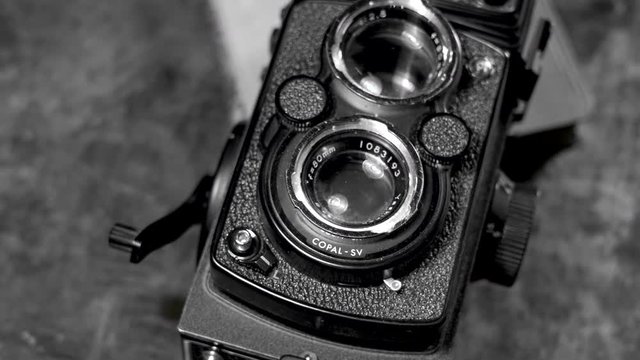 old camera on dark background in black and white
