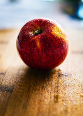 red apple on wooden table