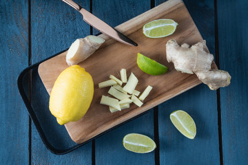 Lemon, ginger and lime on cutting board. Concept of healthy food