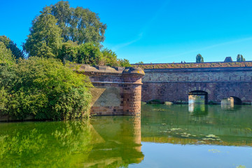 Fototapeta na wymiar Strasbourg, France. Old bridge Barrage Vauban over the Ill river, Alsace.