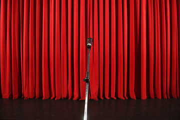 Microphone in front of a red curtain