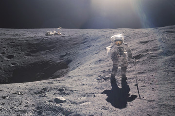 Astronaut on rock surface with space background. Elements of this image furnished by NASA