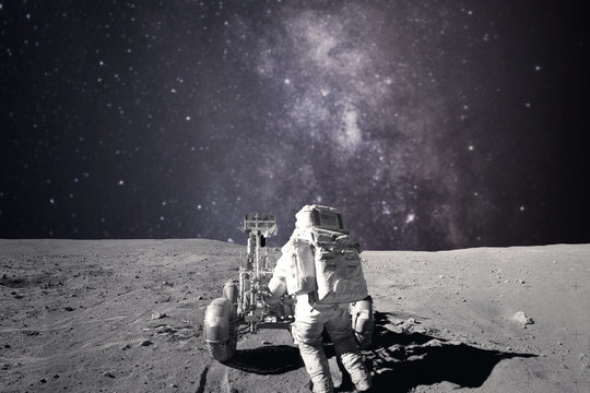 Astronaut on rock surface with space background. Elements of this image furnished by NASA