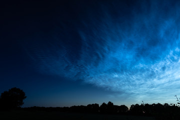 Blue silvery clouds or noctilucent clouds or night shining clouds over Holland. Stunning landscape during twilight.