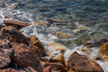 Spring beautiful day by the sea on the rocky seashore of the southern suburbs of Athens, Greece.